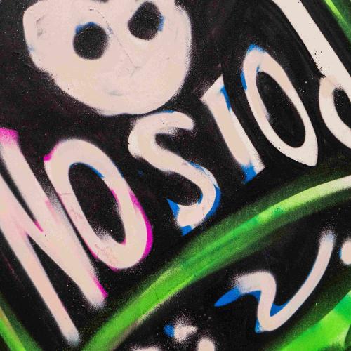 Close up of a graffiti image of a giant poison bottle
