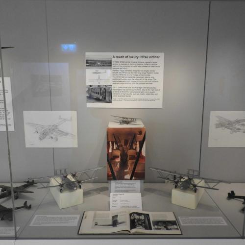 Models of the HP42 airliner and a photograph of its interior with cane chairs