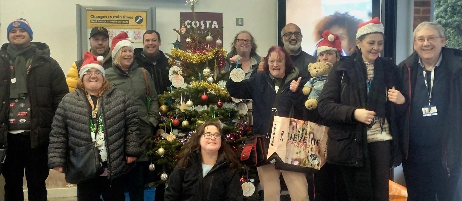 Colour photograph of members of Passport to Leisure around a christmas tree