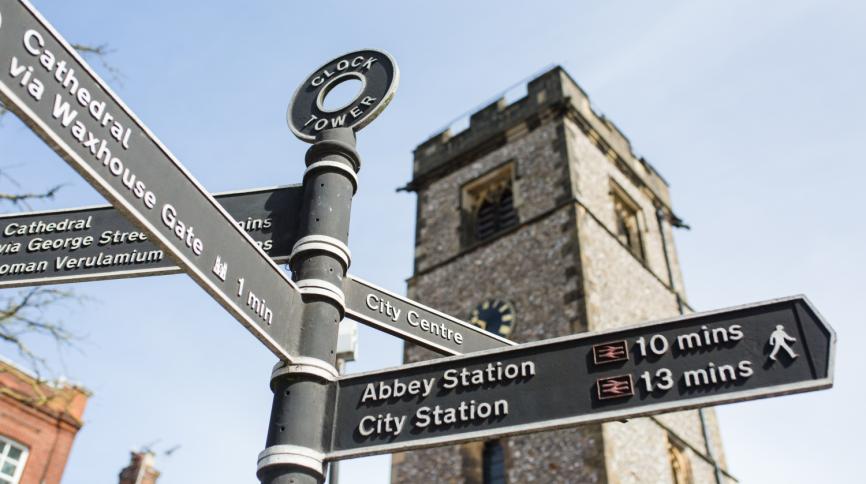 Photograph of the Clock Tower with signposts in front of it