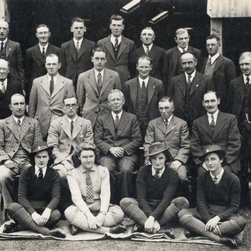 Group portrait of staff from Rothamsted experimental station in 1943, with women in the front row, seated, in Land Army uniform