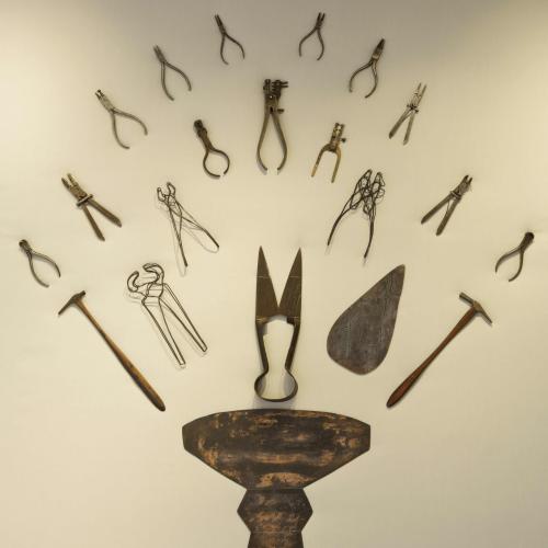 Katy Gillam Hull's metal tools and artefacts displayed symmetrically on the gallery wall