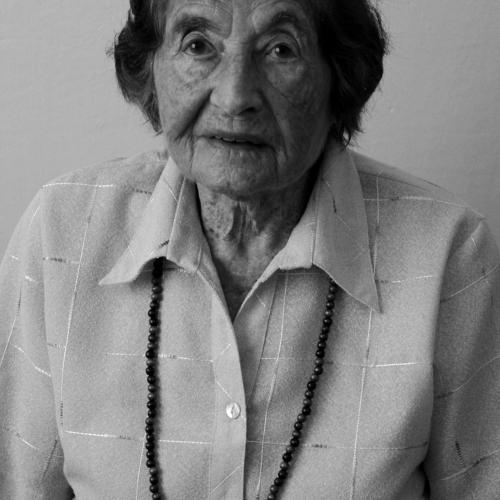 Permanent I, b&w photographic portrait of a woman wearing a white shirt and a long necklace