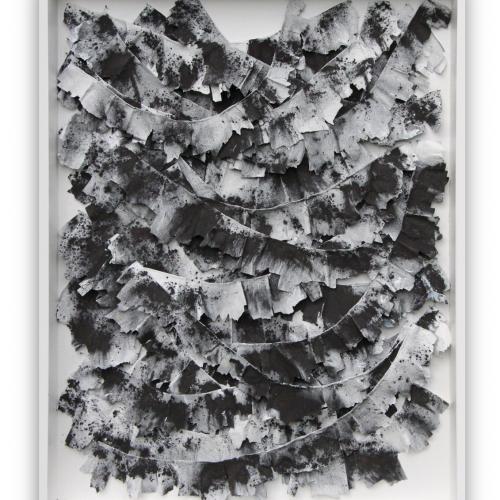 Graphite, framed rectangular composition of pieces of papier mache painted black and white and hanging from wires hung across the frame