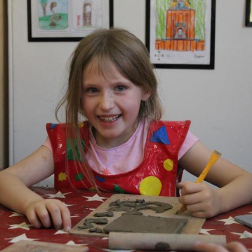 child playing with clay