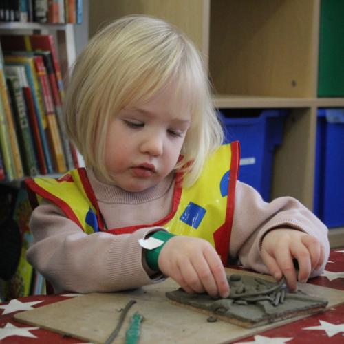 child playing with clay