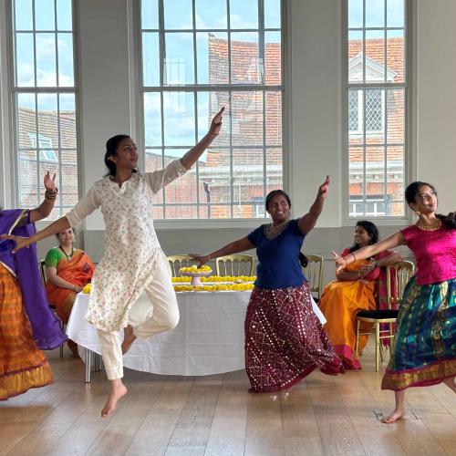 Dancers performing an Indian dance in traditional dress in the Assembly Room