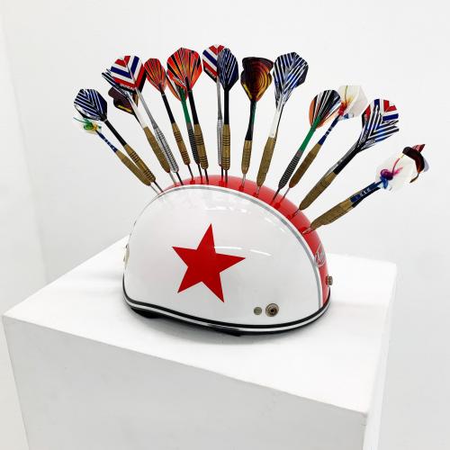 Untitled (Helmet and Darts), darts on top of a white helmet with a single red stripe, side view