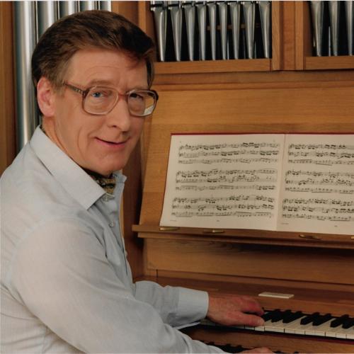 Peter Hurford sitting at an organ console