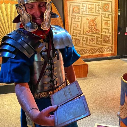 Roman soldier looking at a wax tablet