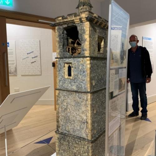 A scale model of St Albans Clock Tower with the top floor left open so you can see the bell mechanism