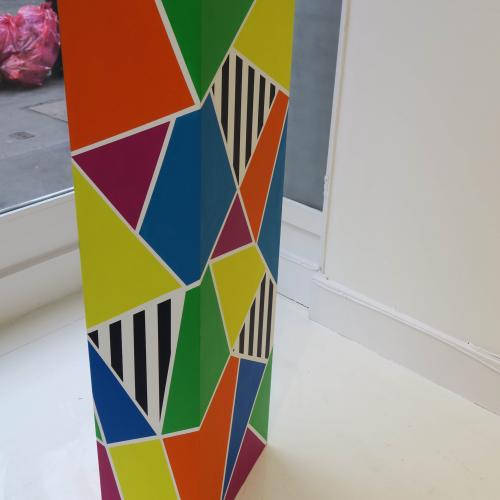 Plinth, geometric coloured patterns painted on a plinth 