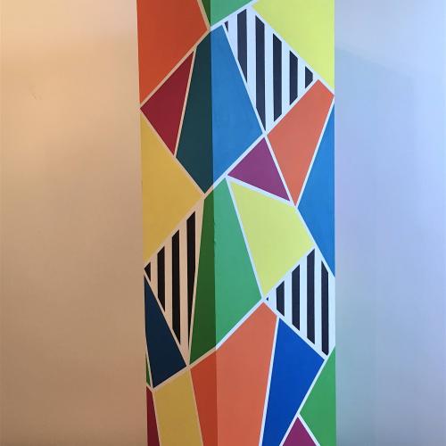 Plinth, geometric coloured patterns painted on a plinth 