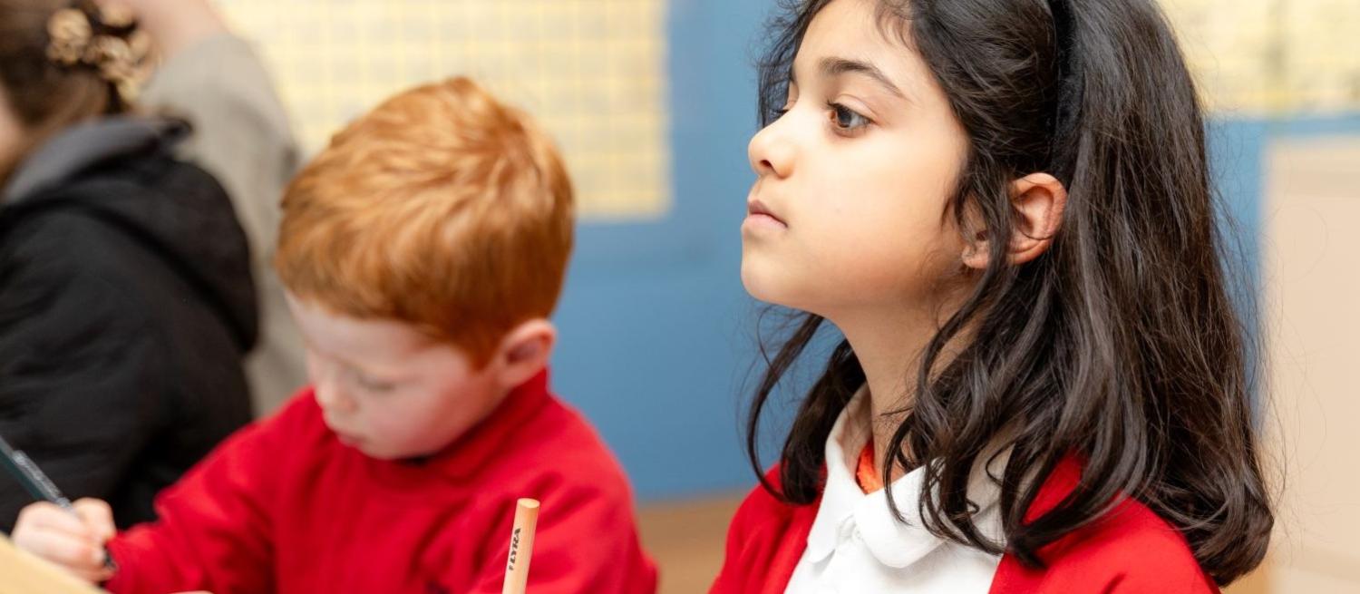 children in red drawing in museum