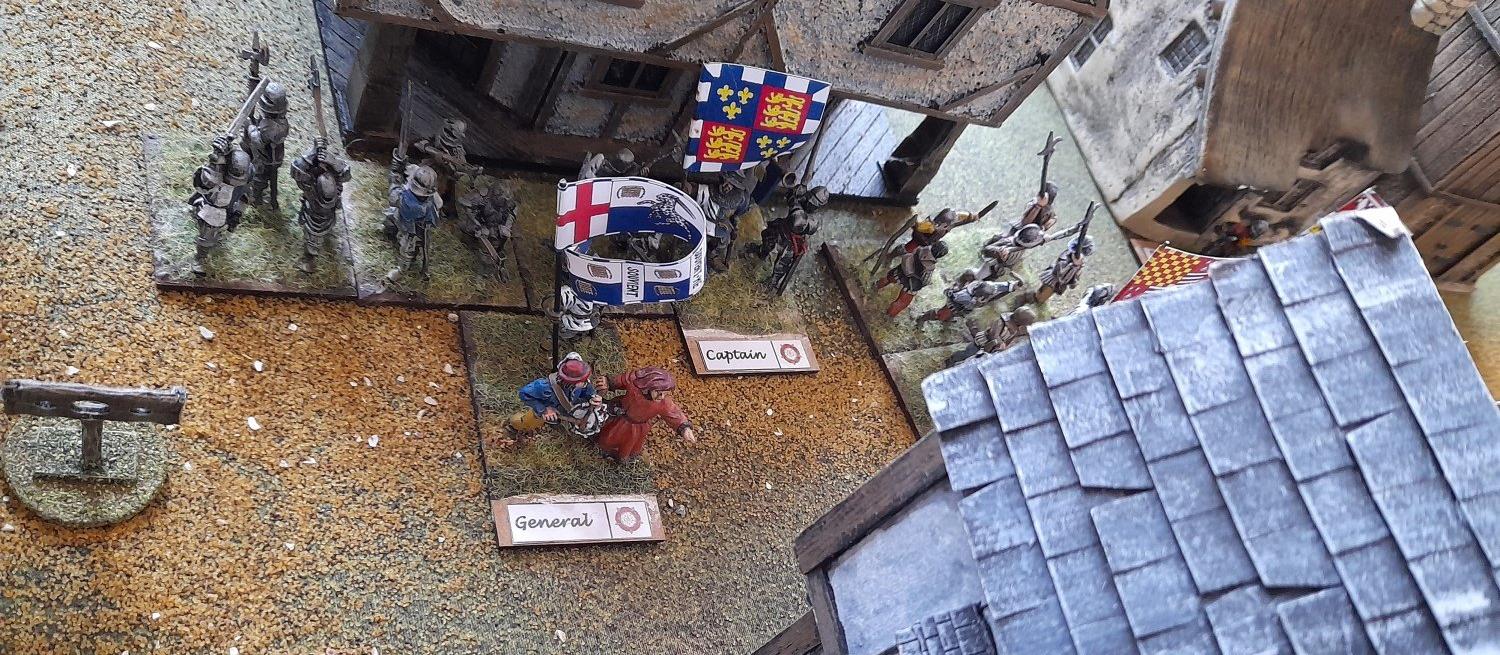 A close up of models showing part of the First Battle of St Albans, a general is outside a half timbered building