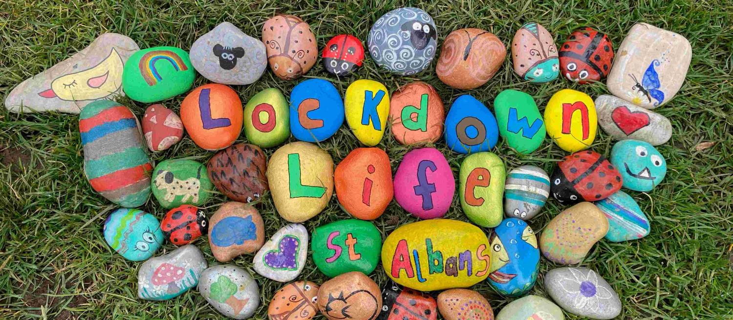Lockdown Life St Albans painted onto rocks surrounded by colourful painted rocks