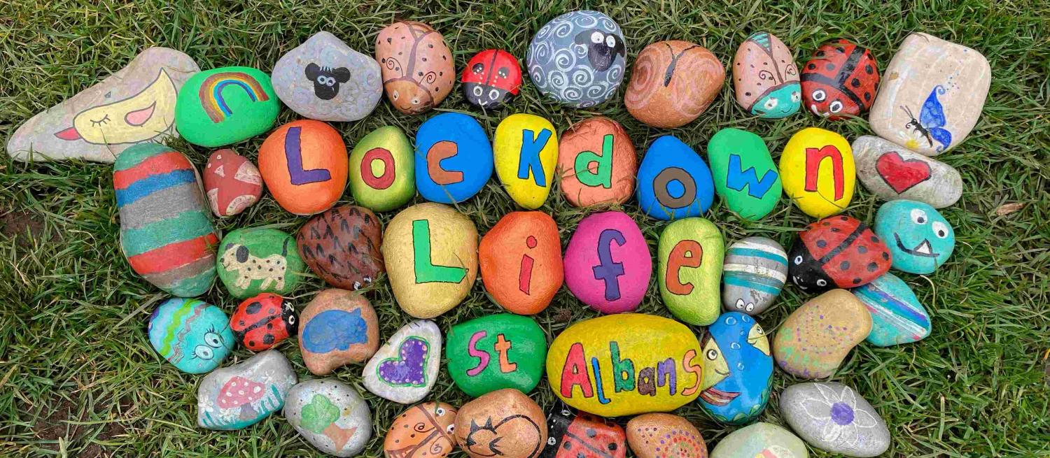 Lockdown Life St Albans painted onto rocks surrounded by colourful painted rocks