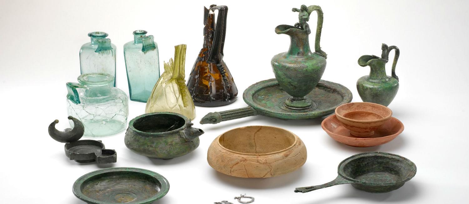 collection of roman objects including glass, pottery and metal containers