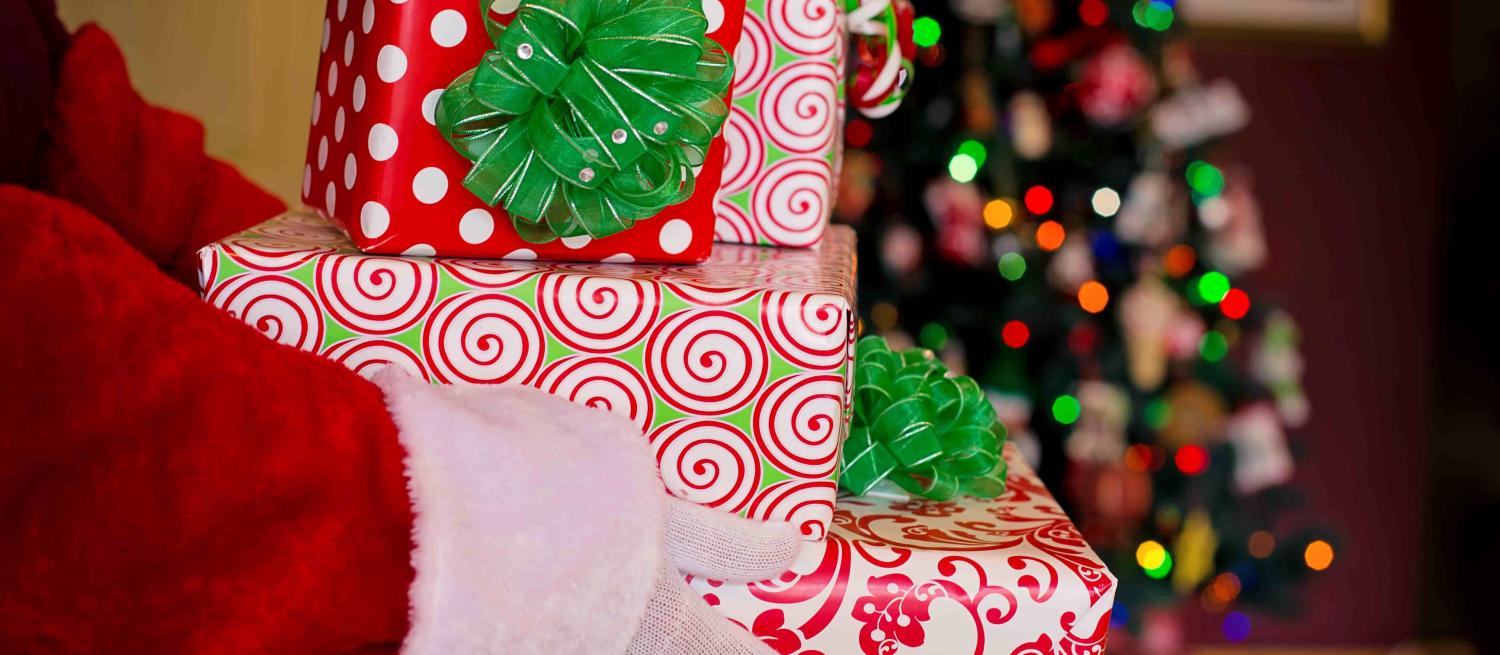 santa hands giving a pile of presents