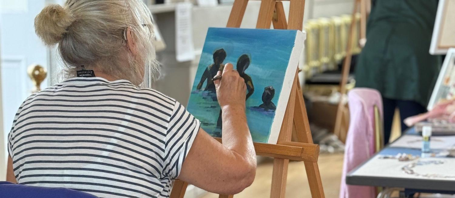 Woman painting on an easel