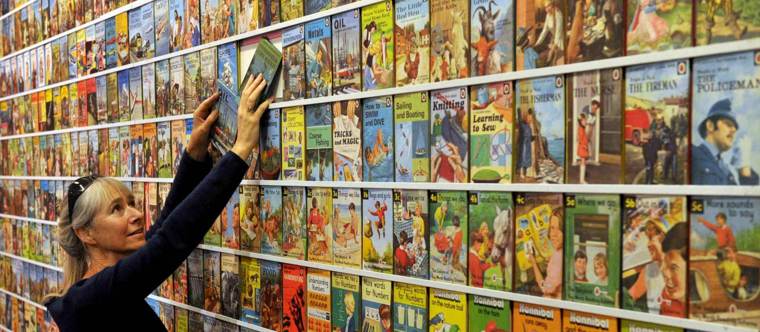 Helen Day adding ladybird books to wall