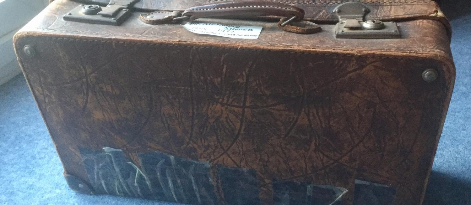 Old suitcase on a blue background