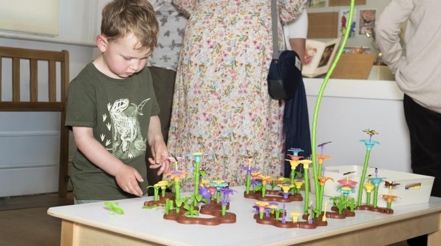 Child playing with toy flowers