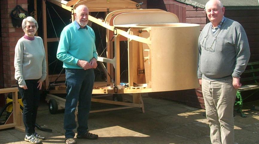 Three members of the Paralyser Group next to their part built, full size O/400 aircraft model