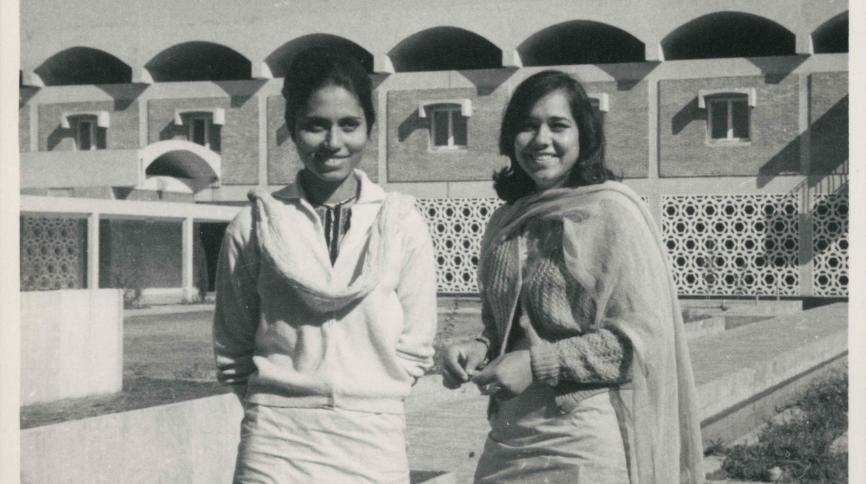 Monochrome photographic print showing Shamima Hasan and friend in front of Pujab University, Lahore, Pakistan. Shamima graduated in 1968.