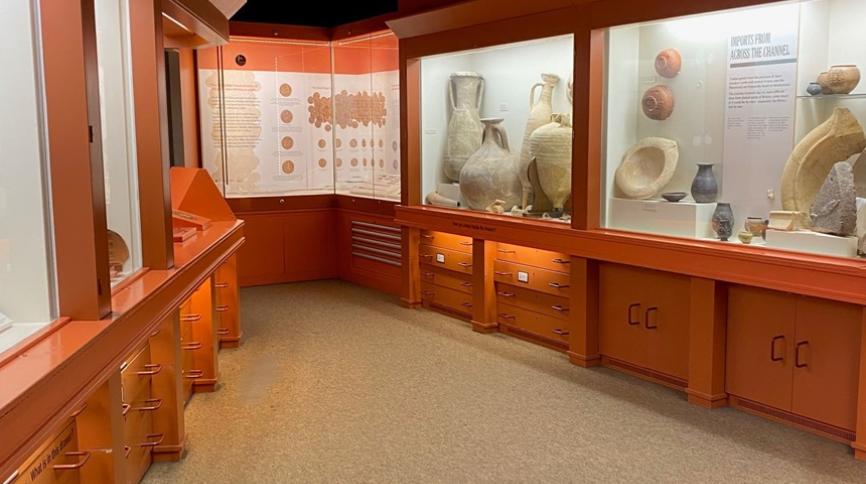 A room with artefacts behind glass, you can see large amphoras on the right of the image.