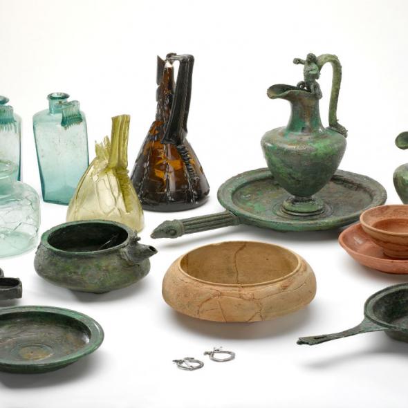 collection of roman objects including glass, pottery and metal containers