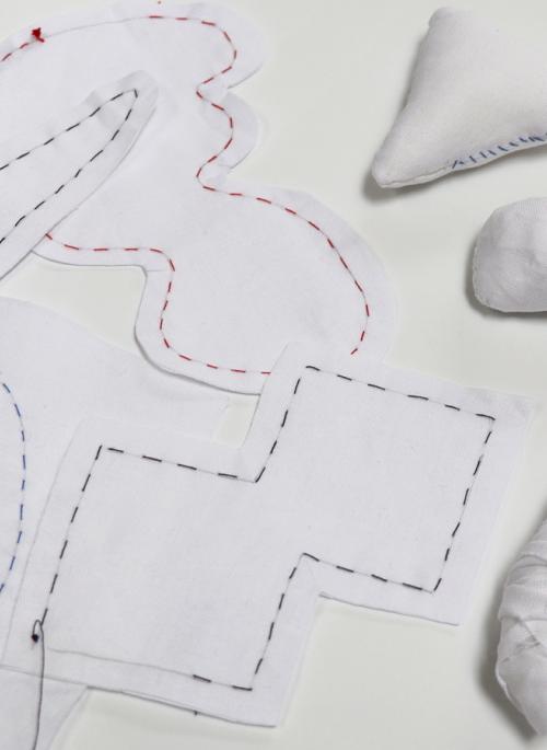 Sewn shapes in white fabric