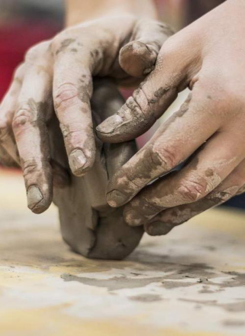 Hands crafting clay