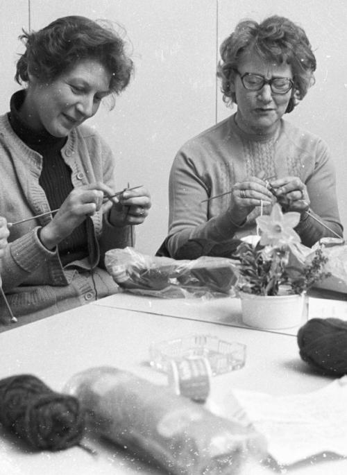 Women sat in a group doing craft