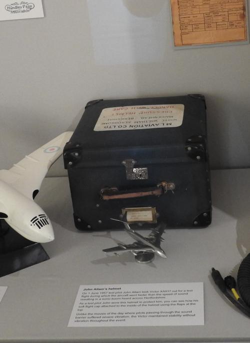 An exhibition case containing a flight helmet and model HP Victor aircraft