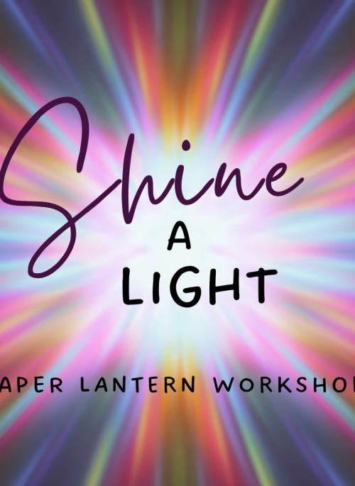 rays of different coloured light behind black text which reads shine a light paper lantern workshop