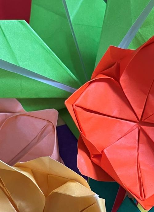 Several colourful origami flowers and leaves.