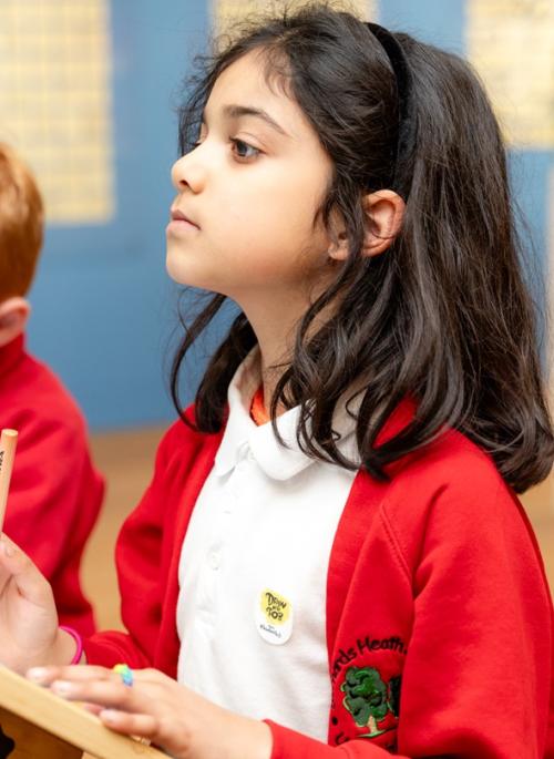 child in red drawing in museum