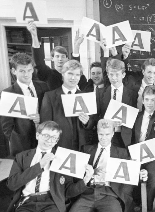 Black and white image of Beaumont students holding up A grades 1987