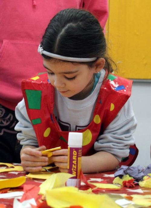child concentrating on craft activity