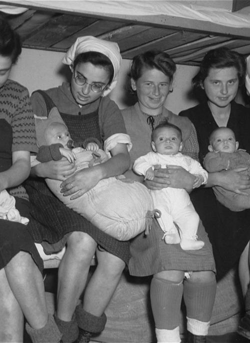 5 Jewish women sitting with their babies after being liberated from concentration camps