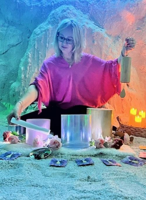 woman playing singing bowls