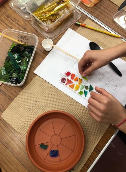 person making glass suncatcher