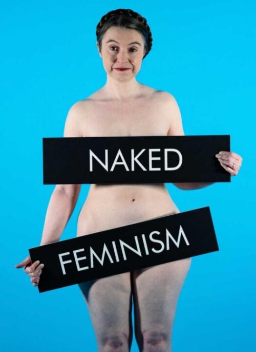 Victoria Bateman posing with signs reading "Naked Feminism"